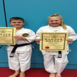 Joseph & Cydney wearing their new Black Belts and showing off certificates